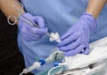 Clean nurse with sterile gauze stopper of bag of nutrition enteral in a hospital Royalty Free Stock Photo