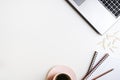 Clean office desk with a laptop computer, paper clips, notepads and cup of green tea Royalty Free Stock Photo