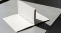 Open blank spiral notebook on a minimalist grey surface, bathed in natural light and shadow Royalty Free Stock Photo