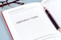 A clean, open notebook displays the heading agreement terms, accompanied by an elegant pen ready for writing. The