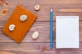 Clean open notepad for writing, pencil, passport and seashell