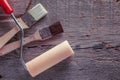 Clean paint roller and two paintbrush on old wood. Copy space for text. Royalty Free Stock Photo