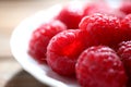 Clean plate with fresh raspberries