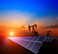 Clean power energy concept,Oil pump with solar panels and the sunset Royalty Free Stock Photo