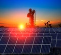 Clean power energy concept,Oil pump with solar panels and the sunset Royalty Free Stock Photo