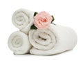 Clean rolled towels with flower on white