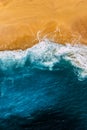 Clean sandy beach with yellow sand and blue sea, vertical photo. Aerial photography of a clean sandy beach. Royalty Free Stock Photo