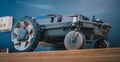 Clean side view of robotic lawnmower, motorized lawnmower being serviced on a table after a year of use in the mud and grass. Royalty Free Stock Photo