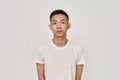 Clean skin. Portrait of young asian man with clean shaven face looking at camera isolated over white background. Beauty