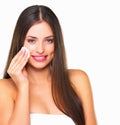 Clean skin is always in. Studio shot of a beautiful young woman using a cotton pad on her face against a white Royalty Free Stock Photo