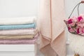 Clean soft colorful towels. Flowers on background