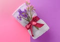 Clean soft towel tied with ribbon on color background