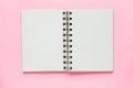 Clean spiral note book for notes and messages on pastel pink background. Minimal business flat lay