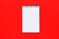 Clean spiral note book for notes and messages on red background. Minimal business flat lay