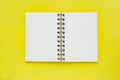 Clean spiral note book for notes on yellow background. Minimal business flat lay mock up