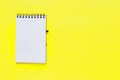 Clean spiral note book for notes on yellow background. Minimal business flat lay mock up