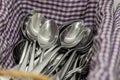 Clean spoons lie on a napkin in the kitchen