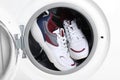 Clean sport shoes in washing machine drum Royalty Free Stock Photo