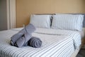 Clean stack of towels in hotel bedroom