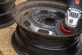 Clean the steel wheel rim with a wire brush attached to the grinder. Royalty Free Stock Photo