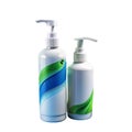 Two white pump dispenser bottles with natural-themed labels against a black background Royalty Free Stock Photo