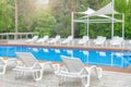 Clean swimming pool and empty resting chair