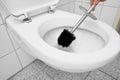 Clean the toilet with a toilet brush while flush Royalty Free Stock Photo