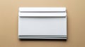 A clean, top-down shot of a crisp stack of white envelopes, perfectly centered on a light brown, textured surface Royalty Free Stock Photo