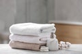 Clean towels, spa stones and soap dispenser on table Royalty Free Stock Photo