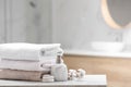 Clean towels, spa stones and dispenser on table in bathroom. Space for text Royalty Free Stock Photo