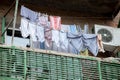 clean underwear and clothes hanging on clothespins on a balcony in a poor area of the city Royalty Free Stock Photo