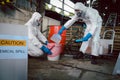 Clean up Chemical Liquid Spill. Scoop Materials into Toxic Waste Red Bag and Thick Plastic Barrels for Disposal, Dispose of