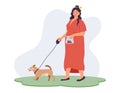 Clean up after your Pet Concept. Young overweight woman walking her dog on a leash on the grass and holding excrement in a plastic Royalty Free Stock Photo