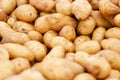 Clean, washed potatoes in light brown, yellow colour on market stall