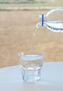 Clean water flows from bottle to glass. Royalty Free Stock Photo