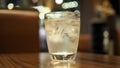 Clean water with ice in the glass on the table. Water in a glass, selective focus. Royalty Free Stock Photo