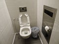 Clean well maintained toilet at the airport. White toilet, trash can Royalty Free Stock Photo