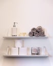 Clean white bathroom shelving with towels toilet paper soap and lots of empty space. Royalty Free Stock Photo