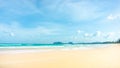 Clean white beach golden brown sand and blue sea under clear blue sky in a sunny day, mountain on background Royalty Free Stock Photo