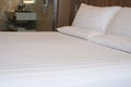 Clean white bed in hotel. White comfortable pillow on bed in bedroom. Bed sheets and pillows. Royalty Free Stock Photo