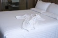 Clean white bed in hotel. White comfortable pillow on bed in bedroom. Bed sheets and pillows. Royalty Free Stock Photo