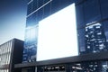 Clean white billboard on shiny glass building exterior with reflections at night time. Mock up Royalty Free Stock Photo