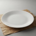 A clean white ceramic plate rests on a textured brown paper sheet. The setting is Royalty Free Stock Photo