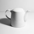 White Ceramic Teapot with Lid and Handle on White Background kettle Royalty Free Stock Photo
