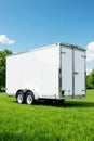 Clean white construction trailer parked on grass, office, clean, work Royalty Free Stock Photo