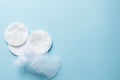 Clean white cotton stack of disk for beauty face hygiene with selective focus on blue neutral background. Cosmetic softness pure