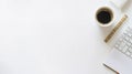 Clean white desk with coffee cup, gold ruler, and partial keyboard view, offering ample copy space for design or text overlay Royalty Free Stock Photo