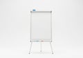 A clean white flip chart easel stands ready for presentations and brainstorming sessions Royalty Free Stock Photo