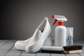 Clean white leather loafers and footwear care supplies