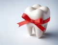 Clean White Molar Tooth Wrapped with Red Gift Ribbon on Gradient Background Royalty Free Stock Photo